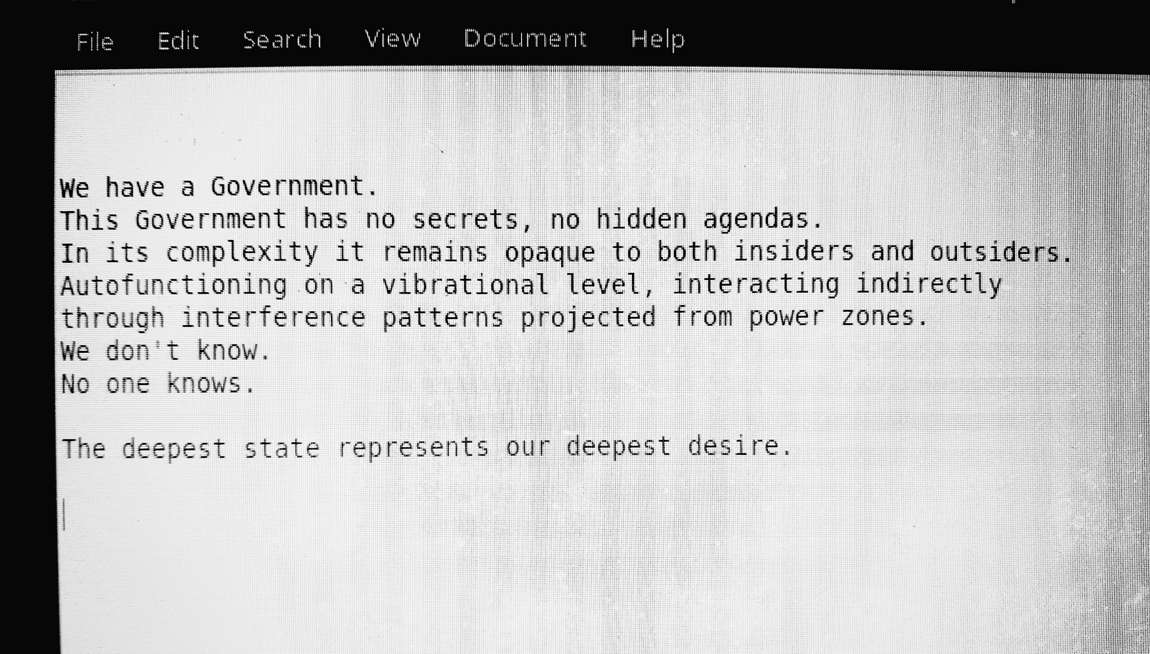 A monitor showing the text: We have a Government. This Government has no secrets, no hidden agendas... The deepest state represents our deepest desire.