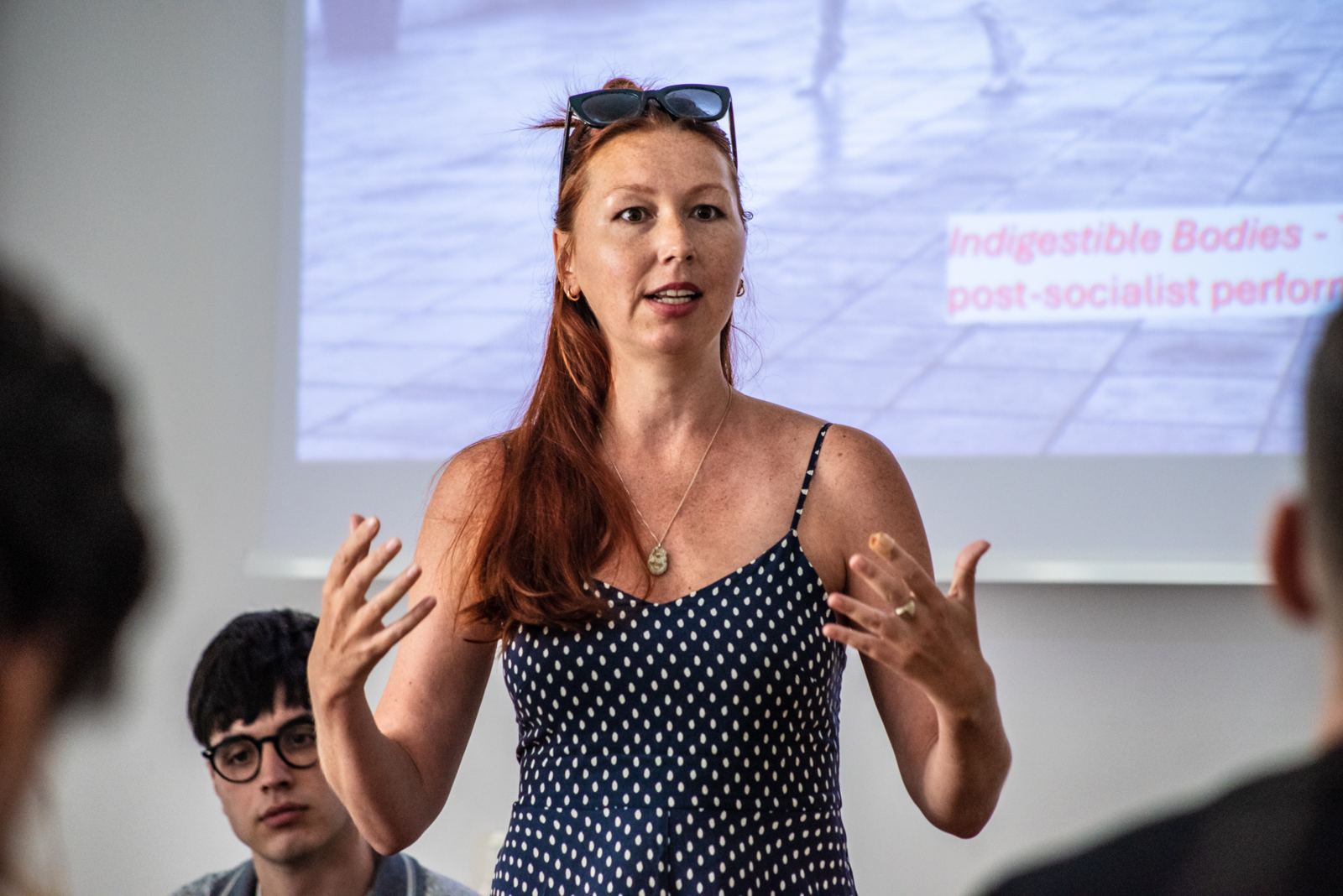 Dasha Filippova speaking at the Ljubljana Summer School, the title of her dissertation, Indigestible Bodies, projected on the screen behind her